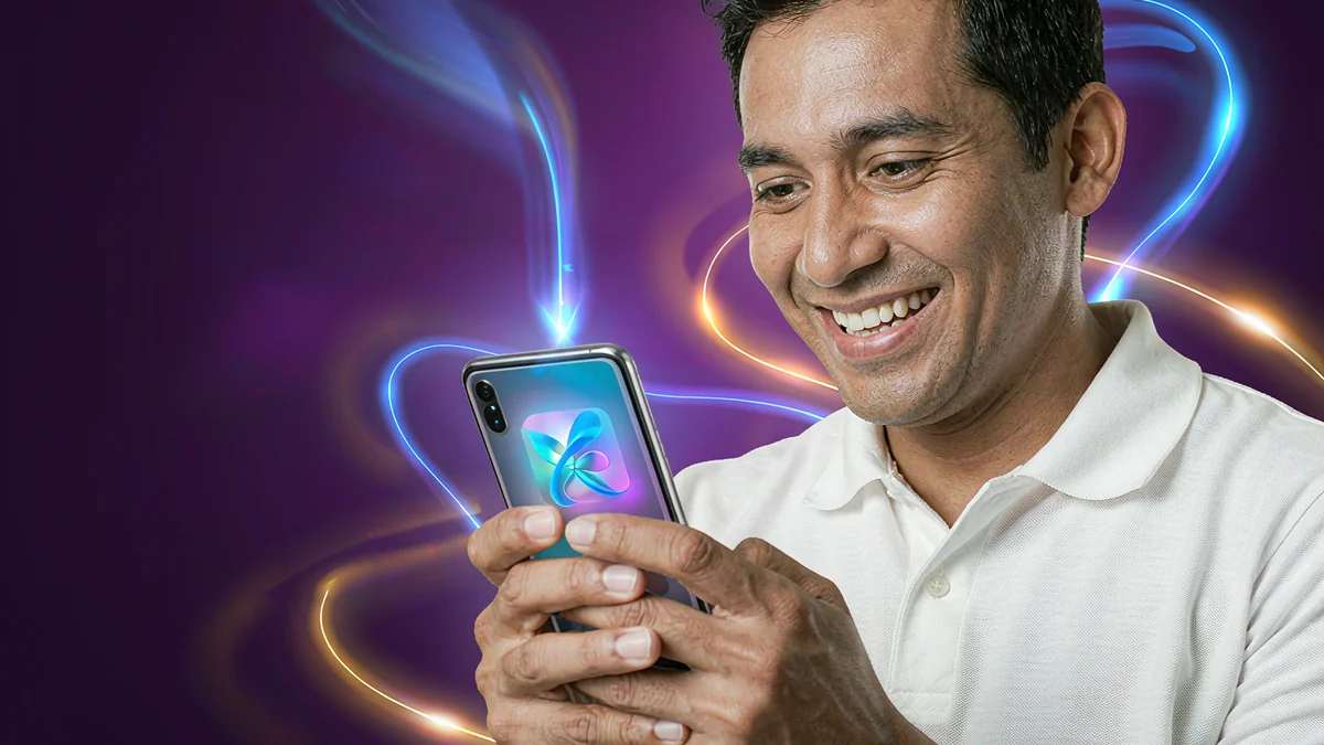 An adult man looking at a smartphone with colourful illustrated light effects — L444 guide