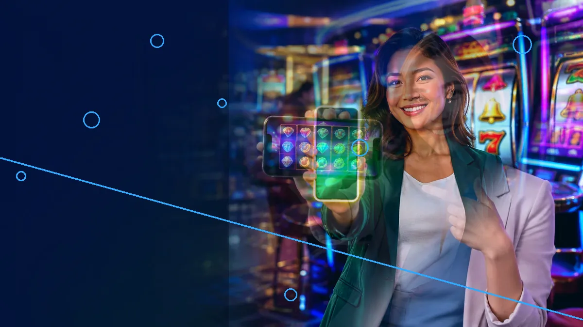 An adult woman holding up a glowing smartphone beside casino machines — L444 guide